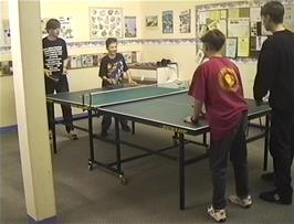 Neil, Eliot and Tao are joined by another hosteller in the games room